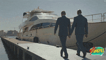 two men holding hands in front of a boat with the word sunken on the bottom