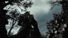 a silhouette of a person standing in a forest