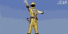 a yellow power ranger is giving a thumbs up in the rain .
