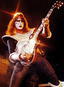 a man playing a guitar with a face painted with a star on it