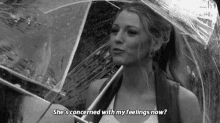 a black and white photo of a woman holding an umbrella and a quote .