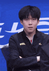 a man wearing a black jacket with chinese writing on it