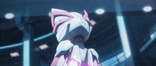 a robot with a pink bow on it 's head is standing in a dark room .