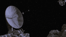 a black and white photo of a satellite with a laurel wreath on the bottom