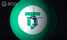 a green ball with a white circle with a t in it