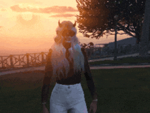 a woman with horns on her head is standing in a park