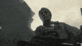 a man with a sniper rifle is standing in the dark