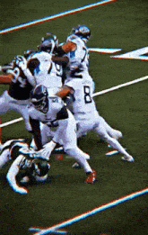 a group of football players are playing a game on a field and one of them is wearing a jersey with the number 23