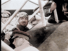 a man wearing a helmet and goggles looks out of a window