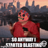 a person wearing a skull mask is holding a gun and saying so anyway i started blasting .