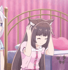 a girl with cat ears is standing next to a bed