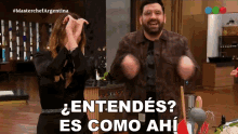 a man and a woman are dancing in a kitchen with the words " entendes es como ahi " on the bottom