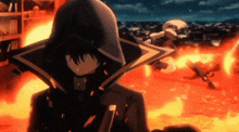a person in a black hooded jacket is standing in front of a fire .