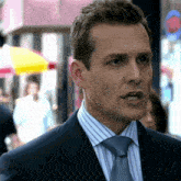 a man in a suit and tie is looking at something