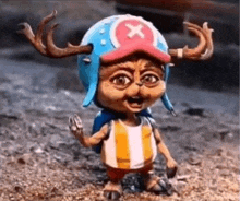 a figurine of a cat wearing a helmet with antlers and a backpack .