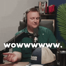a man wearing headphones is sitting in front of a microphone and says wowwwww