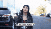 a woman with the name roxanne perez on a sign