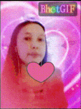 a girl is holding a pink heart in front of her face and the word bhet gif is above her