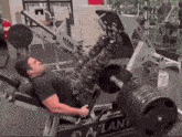 a man is using a leg press machine that says atlantis on it