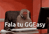 a monkey wearing headphones sits at a desk in front of a computer with the words fala tu ggeasy above it