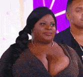 a woman with very large breasts is wearing a very revealing dress and earrings .