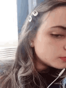 a close up of a woman 's face wearing headphones .