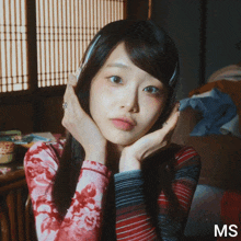 a woman with her hands on her face and the word ms on the bottom right