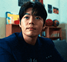 a close up of a man 's face in a room with basketballs on the wall