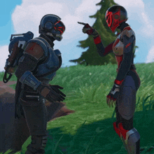a man and a woman are standing in the grass and the man is pointing