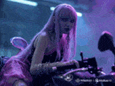 a woman with purple hair is sitting on a motorcycle in front of a sign that says minimax