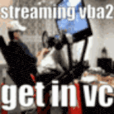 a man is sitting in front of a computer screen with the words `` streaming vba ? get in vc '' written on it .
