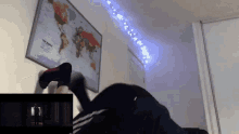 a person is doing a handstand in front of a map that says the world on it