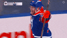an edmonton oilers hockey player holding a stick