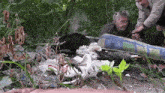 a man with a beard is laying on a blue and white mattress