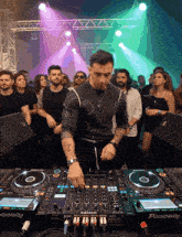 a dj is playing a track on a pioneer mixer
