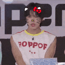a man wearing a poppop shirt with a cat face on his face