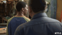 a man talking to another man with a netflix logo on the bottom