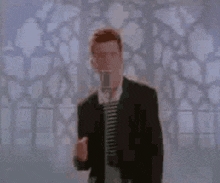 a man in a suit and tie is dancing in front of a stained glass window .