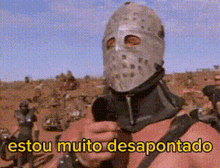 a man wearing a helmet and holding a gun with the words estou muito desapontado above him .