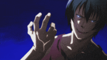 a man with blue eyes and a red tank top is making a fist