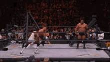 two wrestlers in a ring with the word aew on the ring