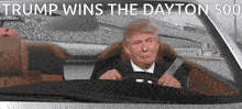 a picture of donald trump driving a car with the words trump wins the dayton 500 above him