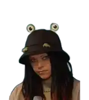 a woman wearing a frog hat with frog ears on it .