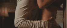 a man and a woman are having sex on a bed . the woman is wearing a black bra .