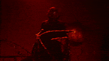 a man in a costume with a heart on his chest is standing in front of a haunted house