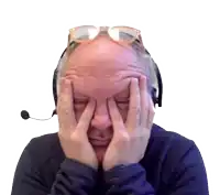 a man wearing glasses and a headset covering his face