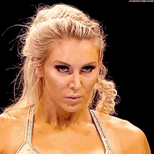 a close up of a woman 's face with a black eye and a ponytail .