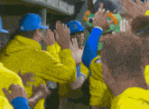 a baseball player wearing a blue hat with the letter b on it gives a high five