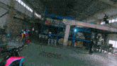 a pink motorcycle is parked in a large warehouse