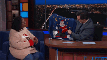 a person wearing a christmas sweater with a santa claus on it